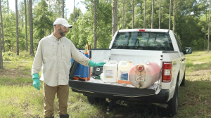 Dr. Enloe in the field describing equipment off the bed of his truck.
